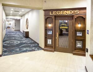 Large Wooden Entry Door to Legend's Bar by Long Corridor