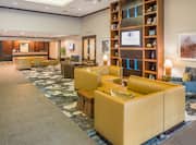 Soft Seating Around Shelves and TV in Lobby Lounge Area