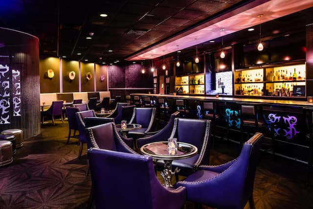 Bar seating area with tables and chairs