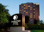 Hotel Signage, Exterior, and Landscaping Illuminated at Dusk