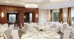 Charles River Ballroom With Place Settings and Flowers on Dining Tables With White Linens and White Chairs