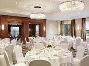 Charles River Ballroom With Place Settings and Flowers on Dining Tables With White Linens and White Chairs