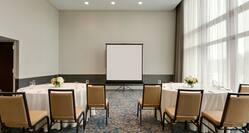 Meeting room with round tables and projector