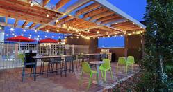 Outdoor Poolside Patio and Lounge Area with Pergola Overhang and Lights