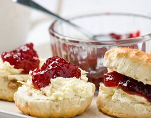 Close-up of scones with cream and strawberry jam