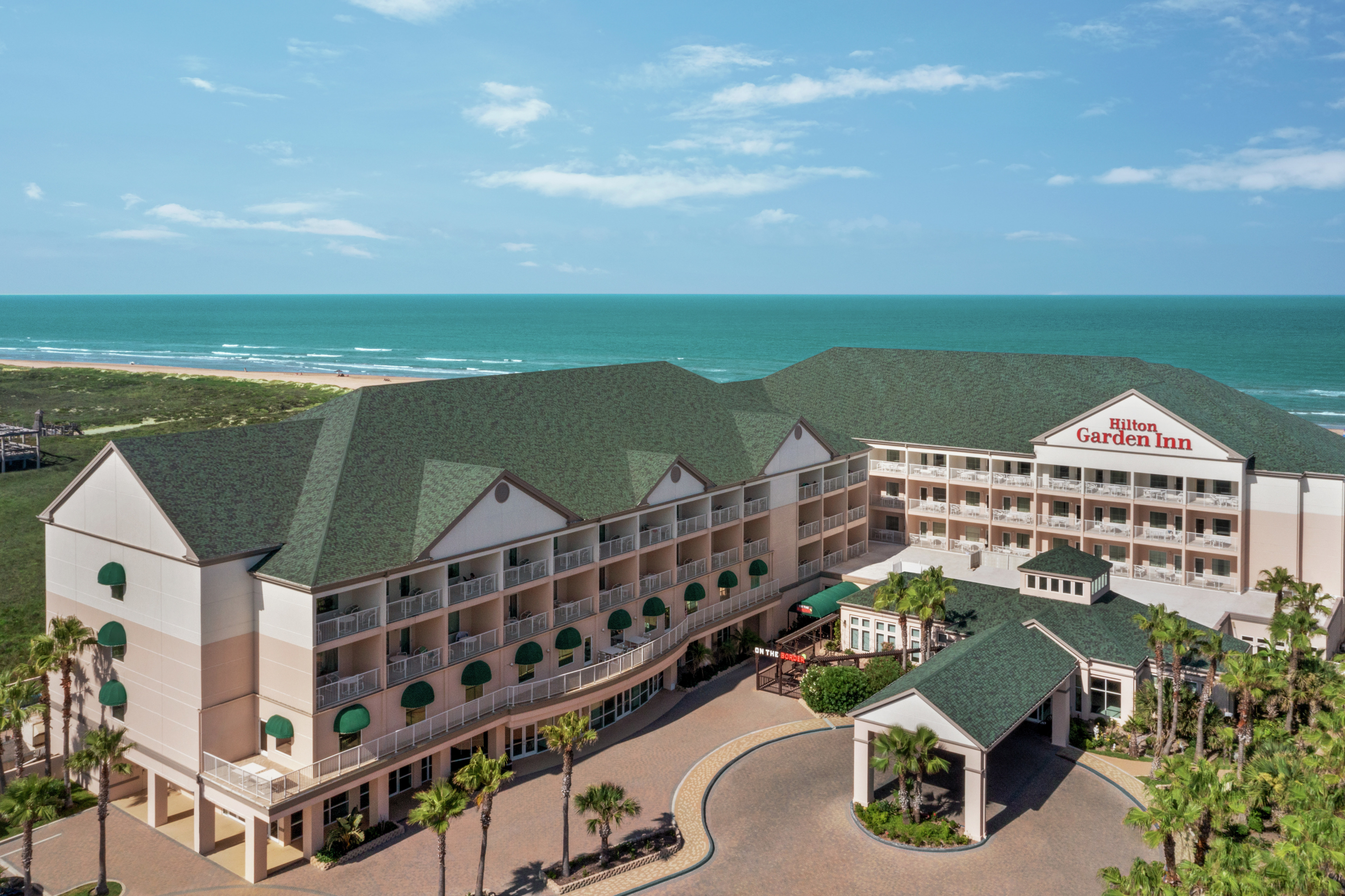 Stunning Hilton Garden Inn oceanside hotel exterior.