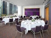 meeting room with oval banquet tables and view of city