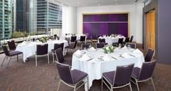 meeting room with oval banquet tables and view of city