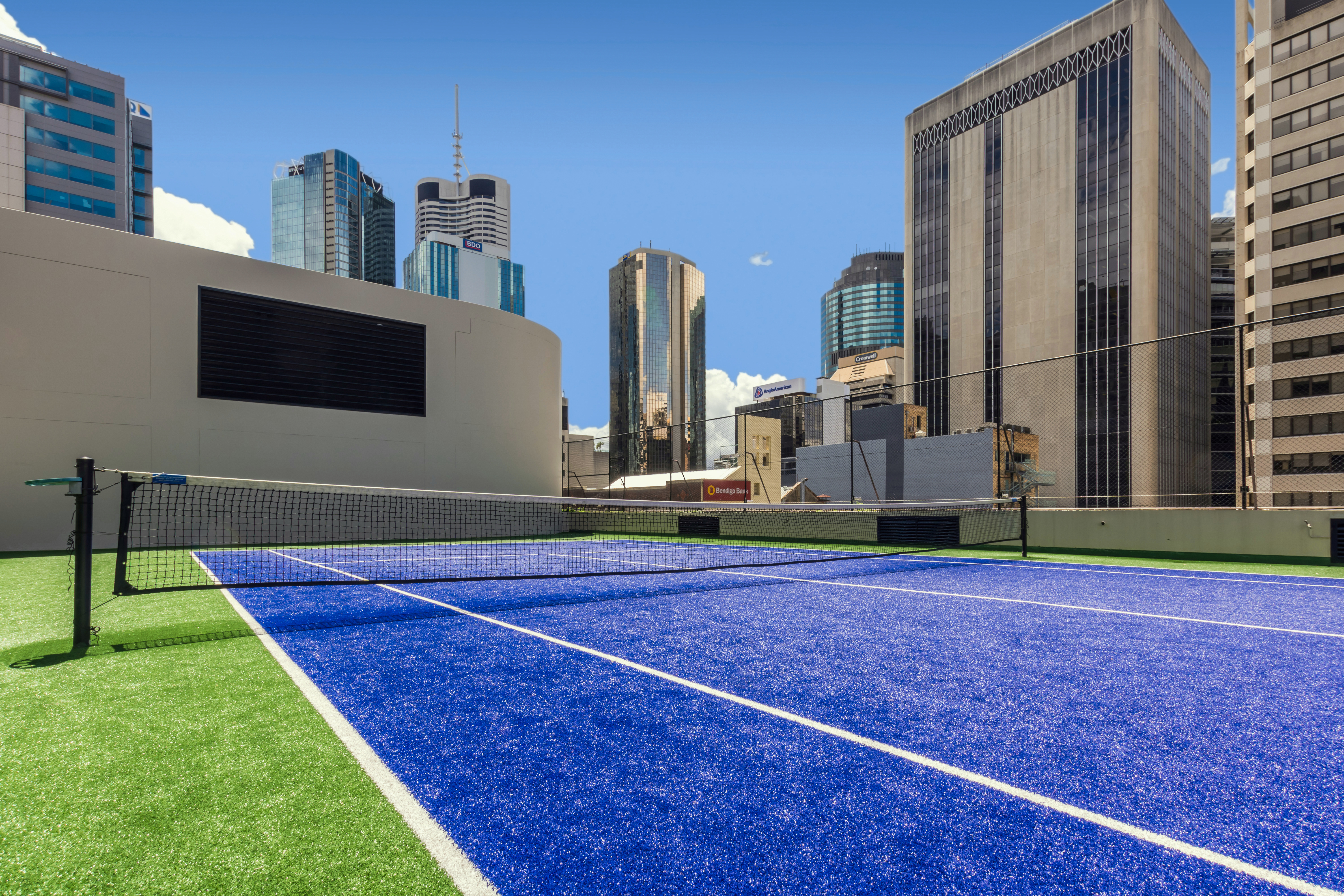 Rooftop Tennis Court and View of City