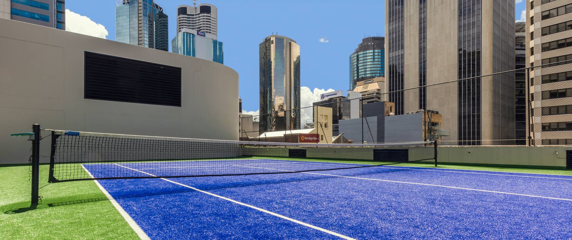 Rooftop Tennis Court and View of City