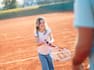 a Girl Playing Tennis with an Adult