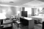Lounge area separated from bedroom area by counter with TV