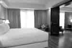King bed with door leading to lounge area