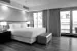 King bed with balcony doors next to it