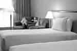 Twin bed with two comfortable chairs in the corner