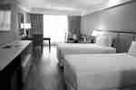 Two twin beds with comfortable chair in the corner