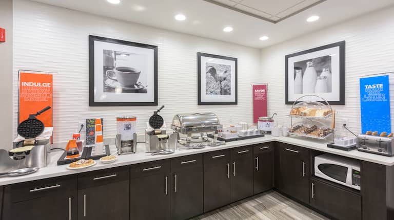 Breakfast Bar Area with Waffle Irons, Pastries, Cereal, and Condiments