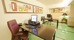 Business Center With Green Floors, Colorful Wall Art, Two Work Desks With Computers and Printers