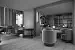 Restaurant seating with round tables, upholstered chairs, lamps, and wood-paneled walls