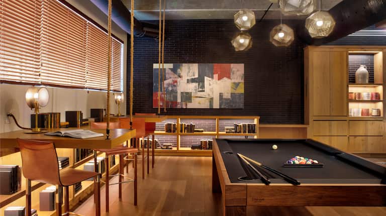 Lobby area with tables, chairs and pool table