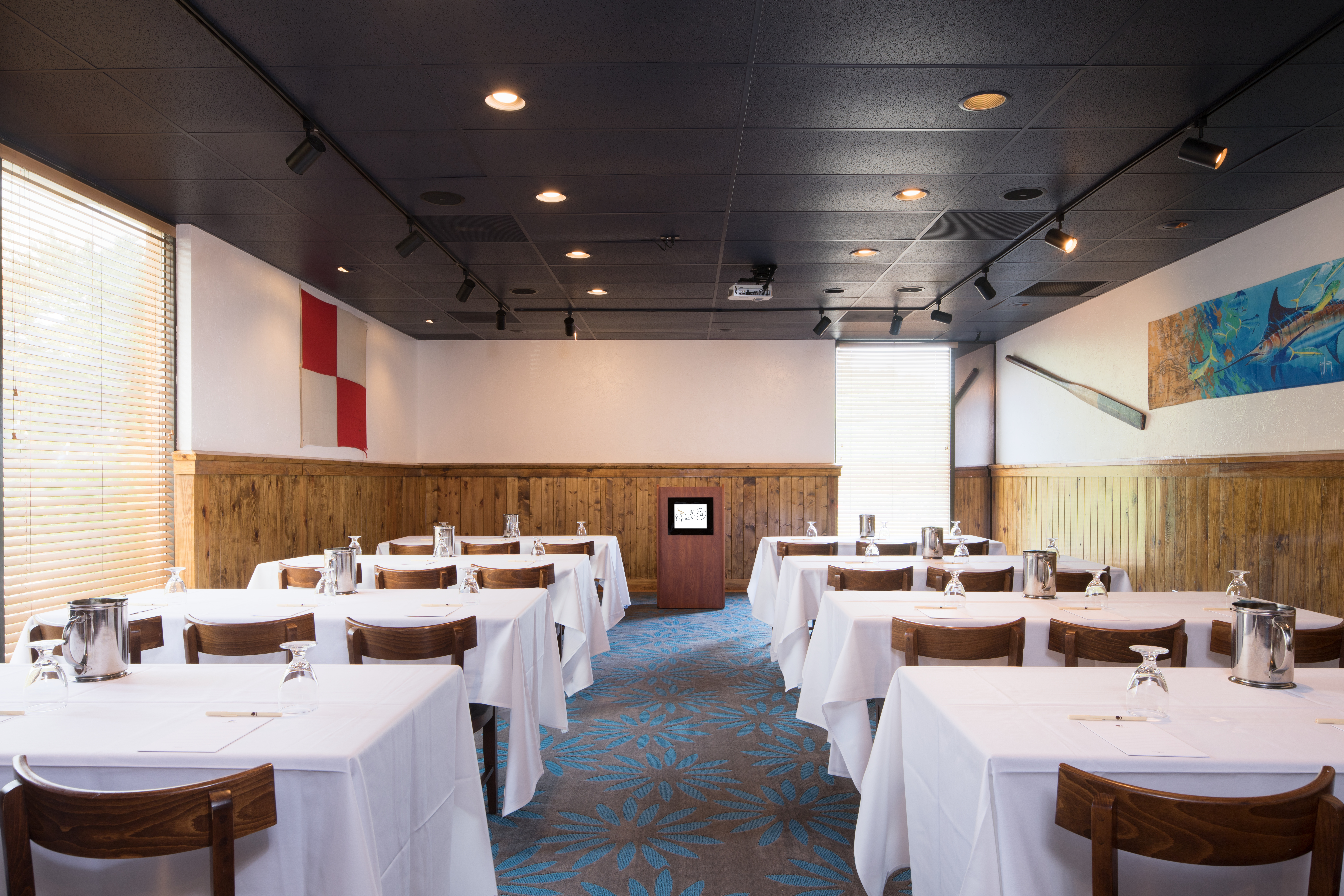 Classroom Setup in The Pier Meeting Room of EJ's Provision Company Restaurant With Tables and Chairs Facing Podium