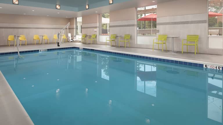Indoor Pool Area with Small Tables and Chairs