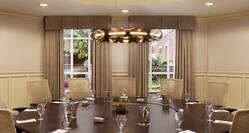 Elegant boardroom in neutral colors set up for a meeting with table in circular setup