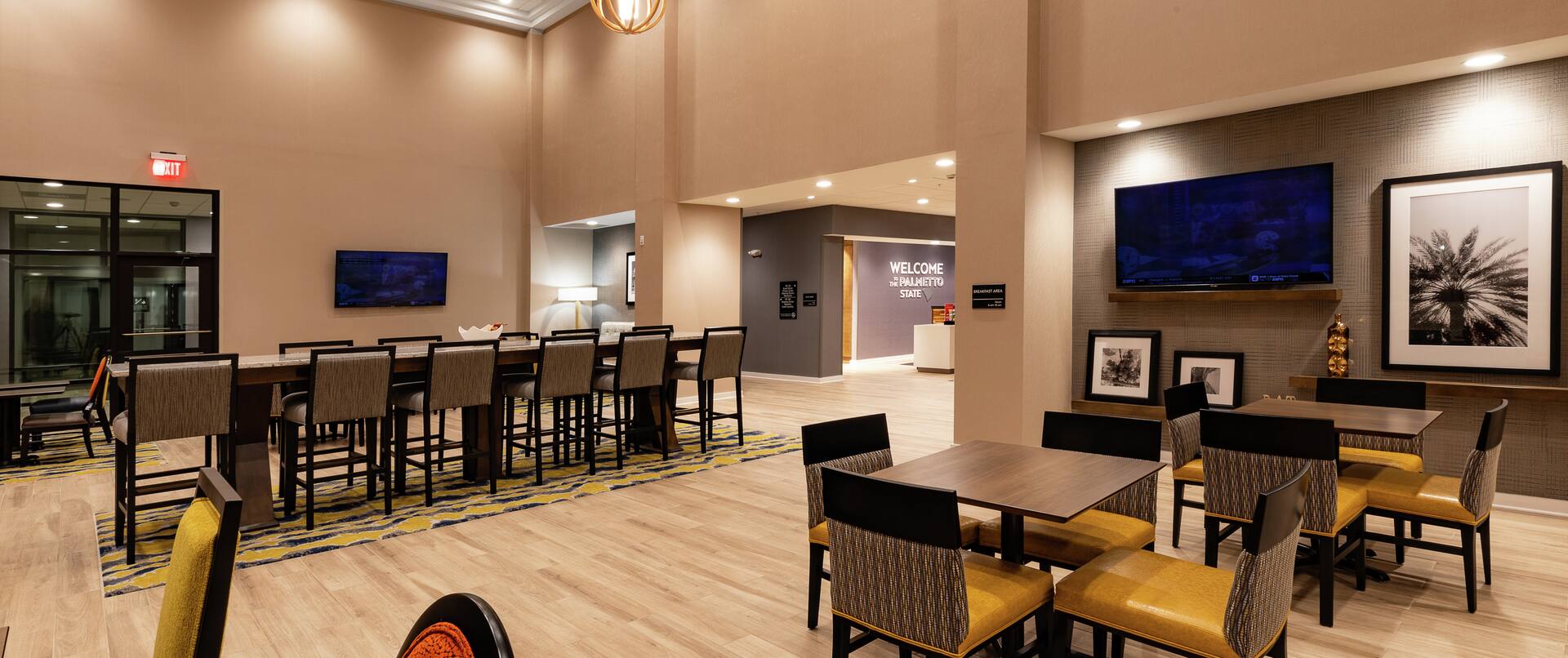 Lobby Dining Area with Large Table and HDTVs