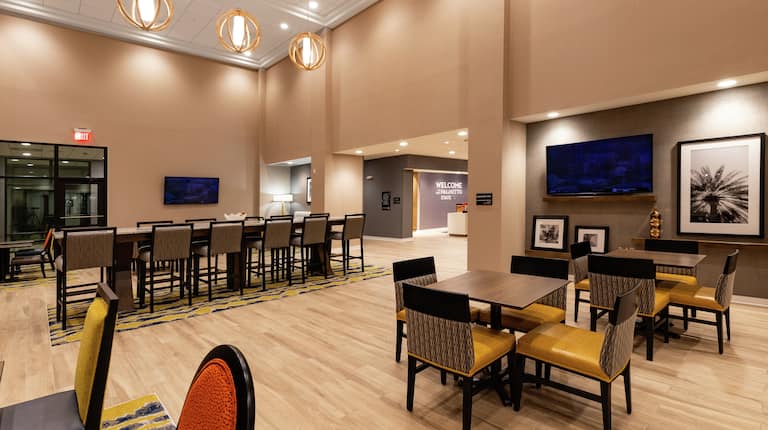 Lobby Dining Area with Large Table and HDTVs