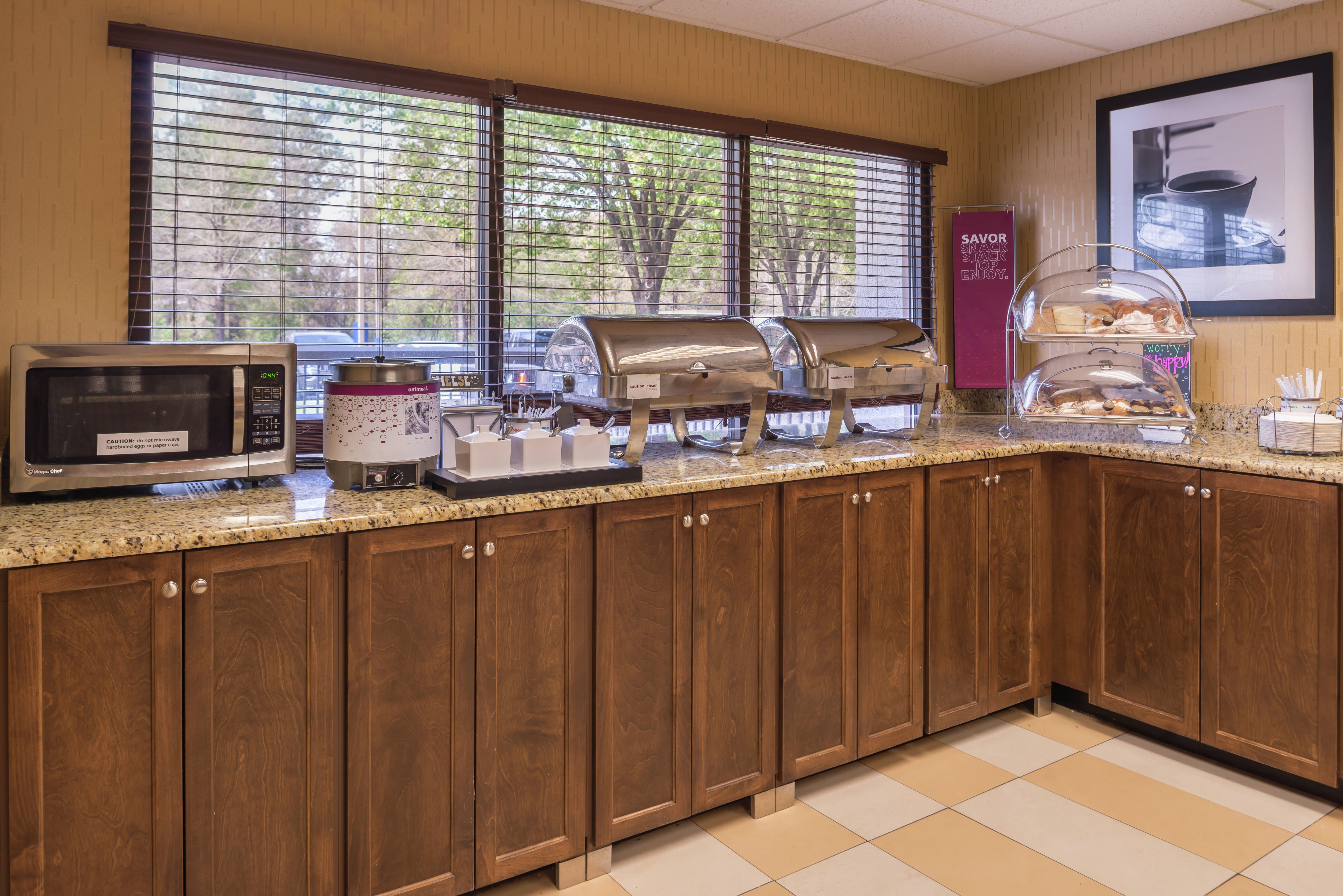 Breakfast Service Area with Microwave, Plates, Utensils, Hot and Cold Buffet Items