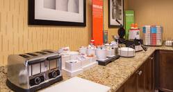 Breakfast Service Area with Toaster, Waffle Iron, and Condiments on Counter