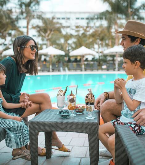 Family Having Ice Cream by the Outdoor Pool Area