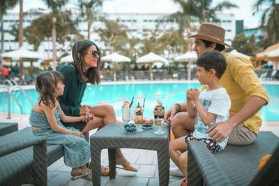 Family Having Ice Cream by the Outdoor Pool Area