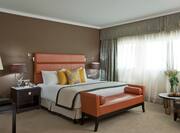 Diplomat Suite Bedroom with King Bed and Lounge Seating