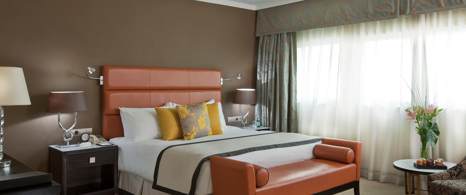 Diplomat Suite Bedroom with King Bed and Lounge Seating
