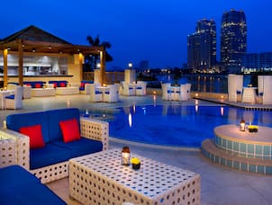 Patio Dining and Outdoor Pool Area at Night