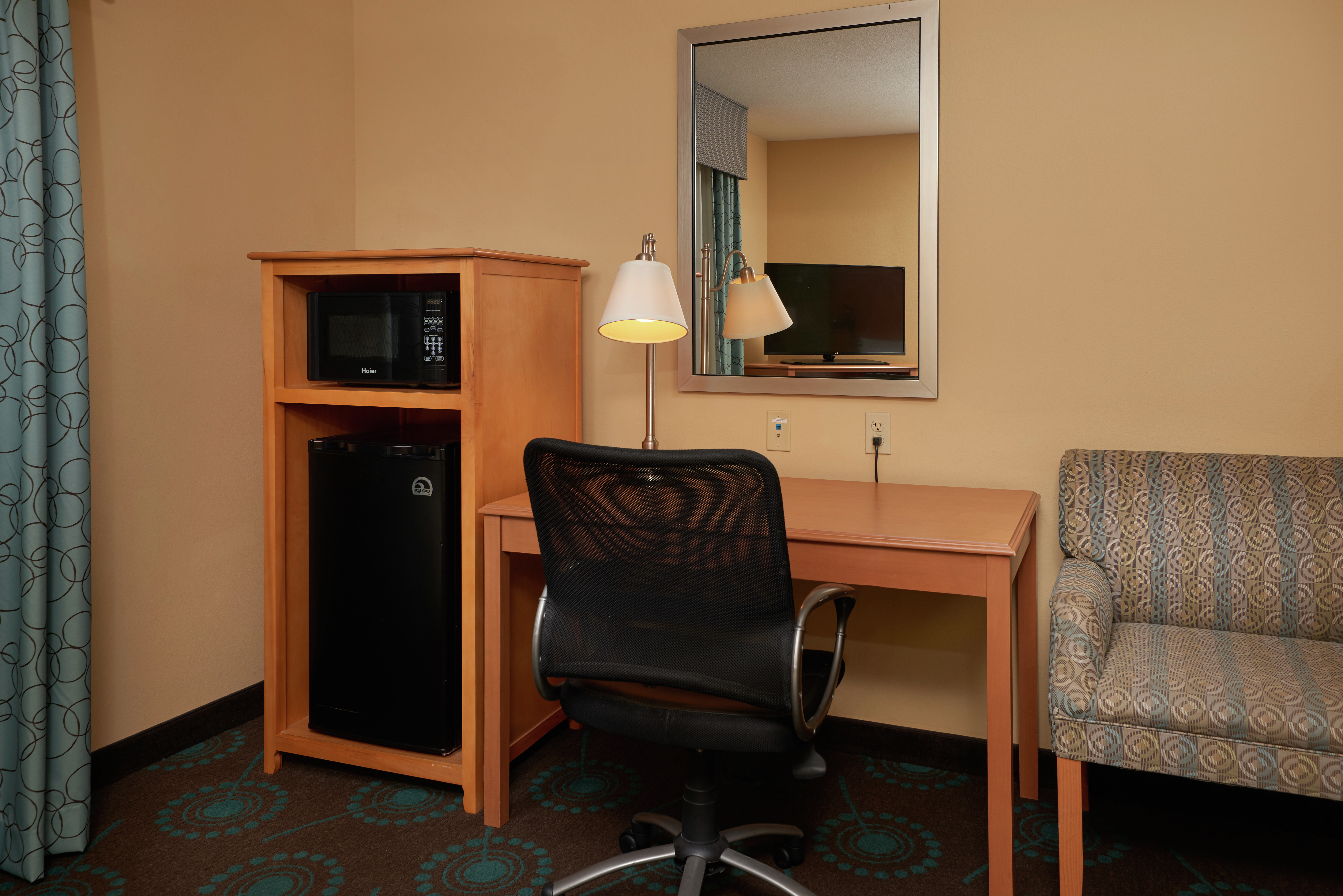Room Amenities such as Microwave Minifridge Work Desk Chair and Mirror