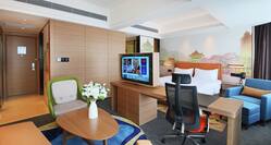 King Bed, Work Desk, Lounge Area, and Television in Suite