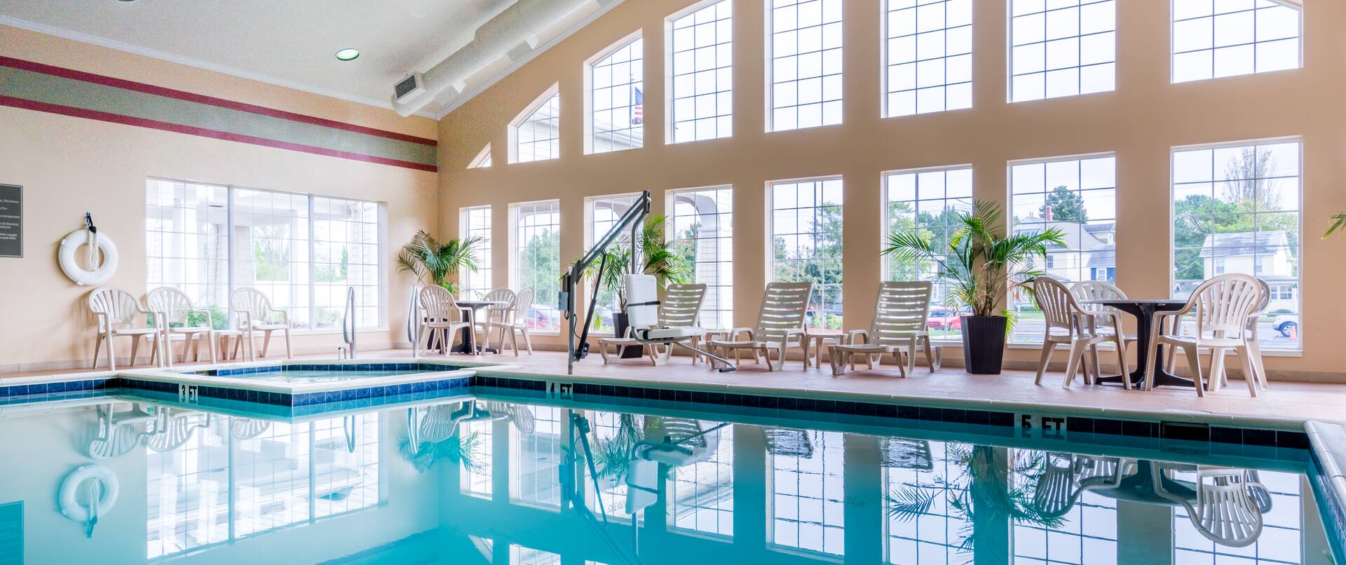 Indoor Pool with Lounge Chairs and Tables with Outside  View