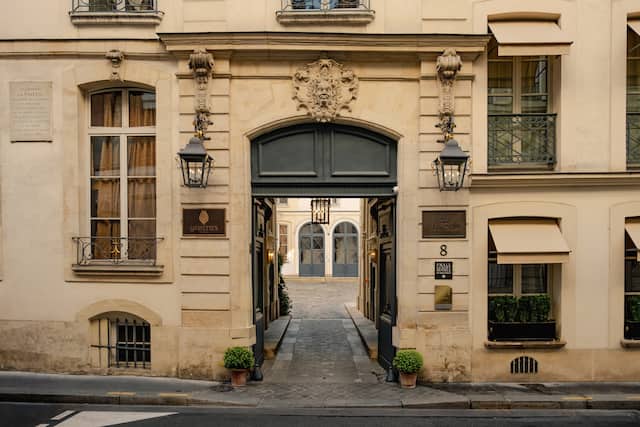 hotel enterance with large archway and ornate windows