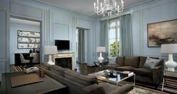 Versailles Suite living area with large comfortable sofas, fireplace and flatscreen TV