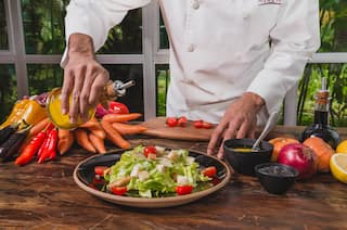 Chef preparing a plate of salad