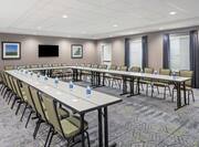 Chairs and U-Shaped Table Setup in Meeting Room