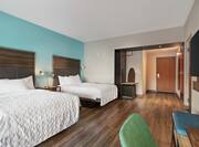 Spacious accessible guest room featuring two comfortable queen beds and TV.