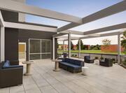 Spacious outdoor patio featuring ample comfortable seating and chess tables.