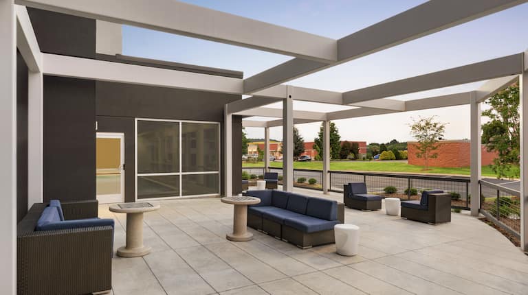 Spacious outdoor patio featuring ample comfortable seating and chess tables.