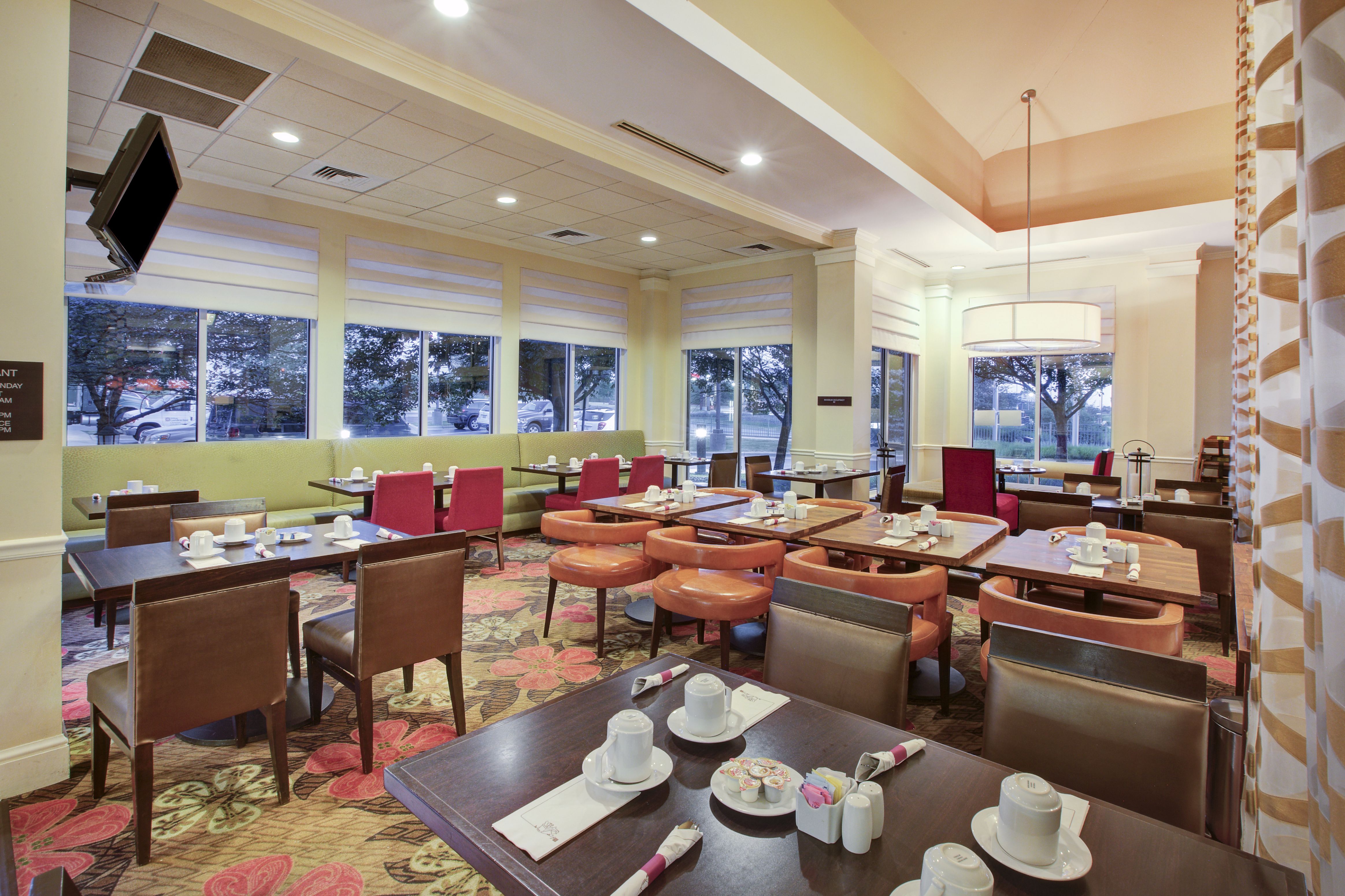 Breakfast dining area with tables, chairs, dining amenities, and windows with outdoor view
