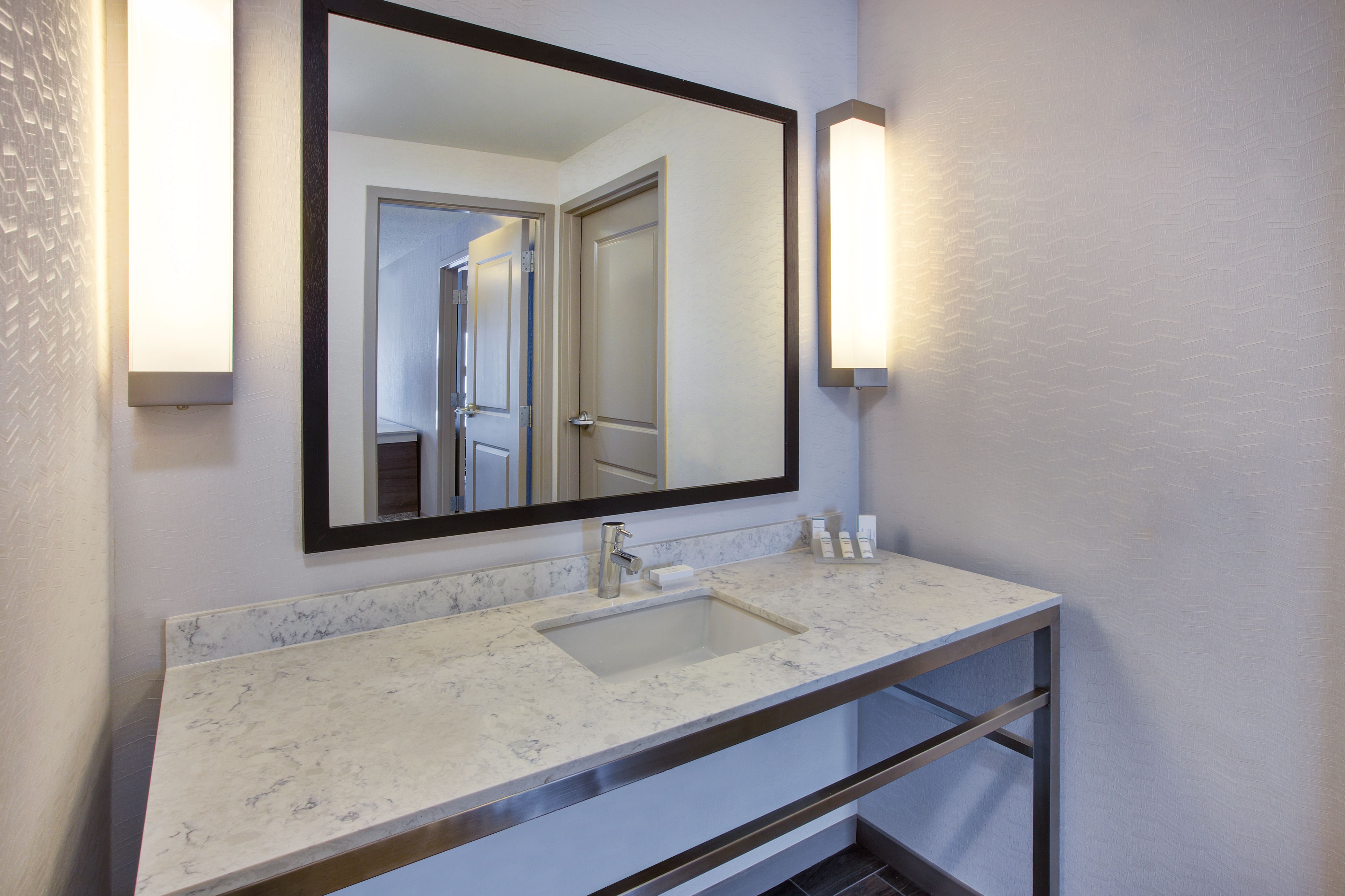 Bathroom with vanity mirror and sink