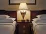 Two Queen Beds Guest Bedroom with Bedside Table and Lamp