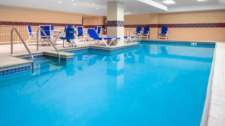 Indoor Pool with Blue Lounge Chairs